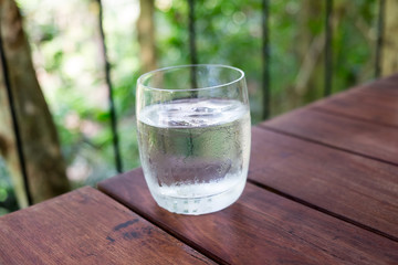 Glass of water on a wooden table