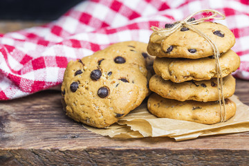 freshly baked chocolate chip cookies on rustic wooden table