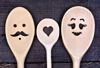 Family wooden spoon on table