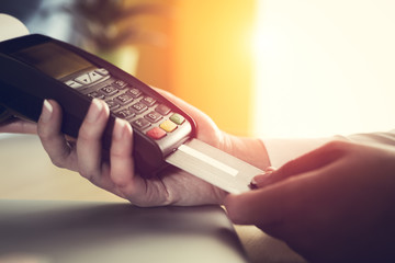 Woman placing credit card into reader