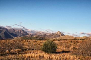Beautiful morning landscape with mountains on a background of blue sky. Italy