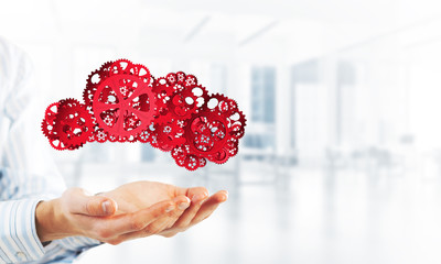 Man presenting in his palms cloud computing concept as mechanism of cogwheels