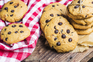 freshly baked chocolate chip cookies on rustic wooden table