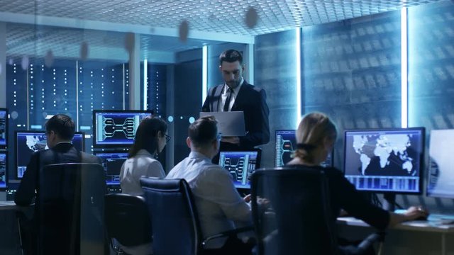 Professional IT Engineers  Working in System Control Center Full of Monitors and Servers. Possibly Government Agency Conducts Investigation.  Shot on RED EPIC-W 8K Helium Cinema Camera.