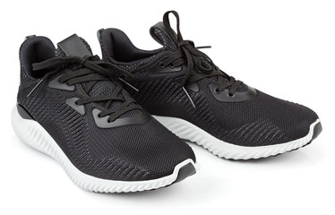 Pair of new unbranded black sport running shoes, sneakers or trainers isolated on white background...