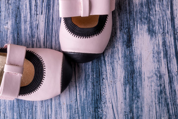 Baby girl pink shoes on colored background. Top view. Copy space.