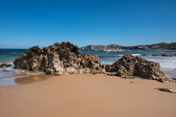Fototapeta na wymiar Scenic beach in the touristic village of Comillas, Cantabria, Spain.