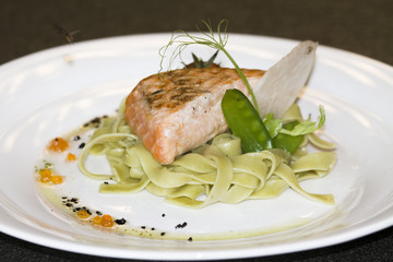 This is fish salmon. It's steamed salmon, peas, Chinese noodles, cherry tomato and a slice of radish.