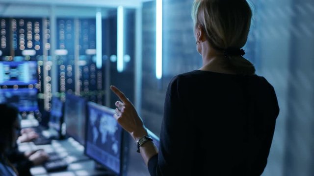 In The Government System Control Center. Female Supervisor Holds Meeting For Her Team of Technical Professionals.Shot on RED EPIC-W 8K Helium Cinema Camera.