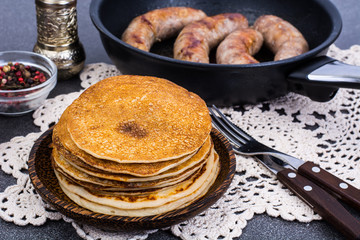 Hot pancakes with homemade sausage in frying pan
