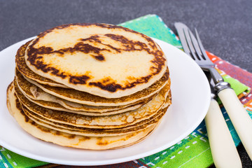 Hot pancakes with homemade sausage in frying pan