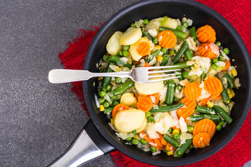 Potato with vegetables, fried in frying pan