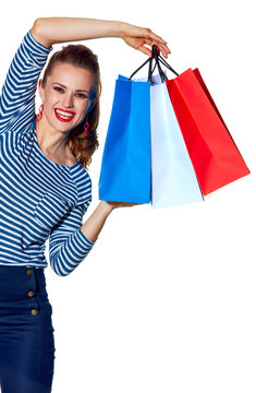 happy fashion-monger showing shopping bags on white background