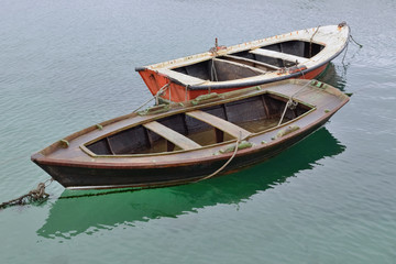 two wooden fishing boats on the water