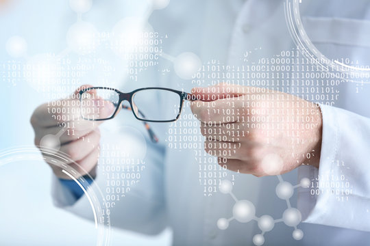 Doctor hands holding glasses on blurred background