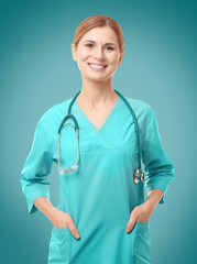 Beautiful young doctor with stethoscope on white background