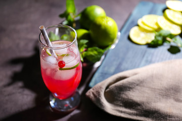 Refreshing cocktail with cranberry on dark table