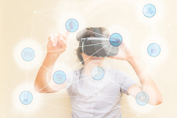 Teenager wearing and touching something in augmented reality wearing VR virtual realty glasses
