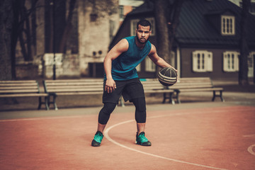 Fototapeta na wymiar African-american streetball player practicing outdoors