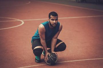 African-american streetball player practicing outdoors