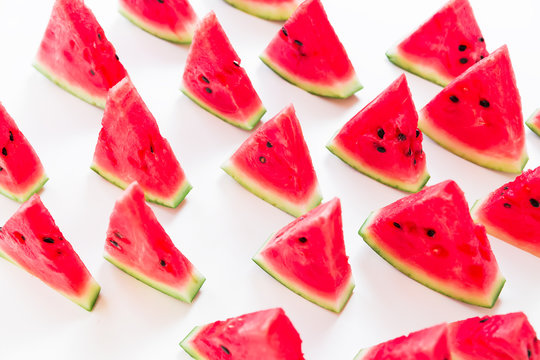 Slices of juicy watermelon on white background. Flat lay. Top view. Summer pattern