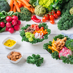 Healthy vegan buddha bowl with kale leaves and raw vegetables