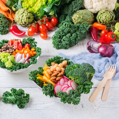 Healthy vegan buddha bowl with kale leaves and raw vegetables