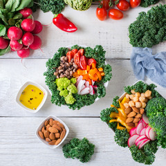 Healthy vegan buddha bowl with kale leaves and raw vegetables