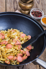 Sour cabbage stewed with slices of sausages