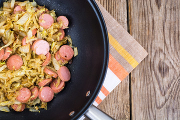 Sour cabbage stewed with slices of sausages