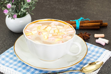 Coffee with milk and marshmallow in white cup