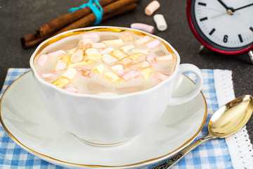 Coffee with milk and marshmallow in white cup