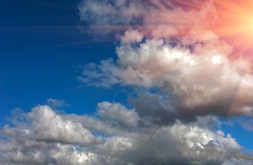 Fototapeta na wymiar Voluminous clouds on a blue summer sky at sunset.