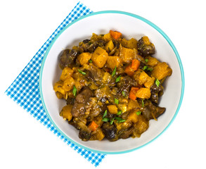 Vegetable stew in a plate on white background