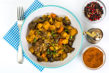 Vegetable stew in a plate on white background