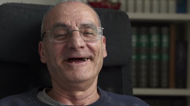 Old man without teeth laughing looking at the camera, Close up portrait