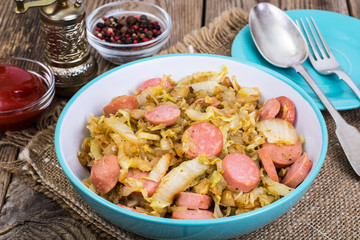 Sliced pork sausages with cabbage in ceramic bowl
