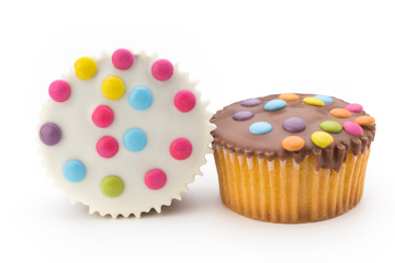 Multiple colorful decorated muffins on a white background.