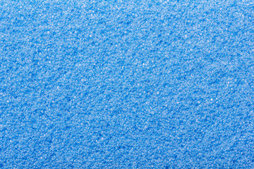 Fototapeta na wymiar Blue foam sponge closeup pattern texture.