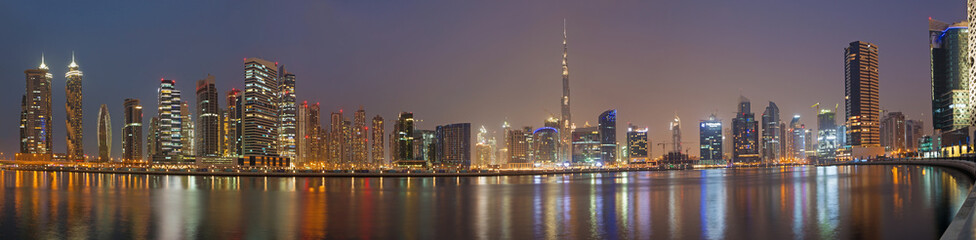 Fototapeta na wymiar DUBAI, UAE - MARCH 23, 2017: The evening panorama over the new Canal with the Downtown and Burj Khalifa tower.