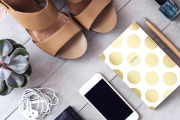 Arranged woman fashion and beauty blogger accessories from above on gray background.  Blogging concept