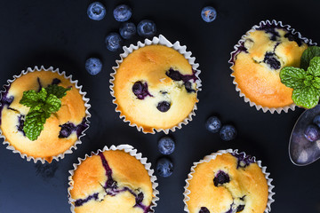 Blueberry muffins with powdered sugar and fresh berries