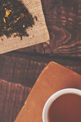 Green natural tea in the jar and a white cup of tea