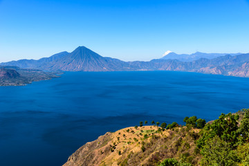 Naklejka na ściany i meble Panorama view of the lake Atitlan and volcanos in the highlands of Guatemala