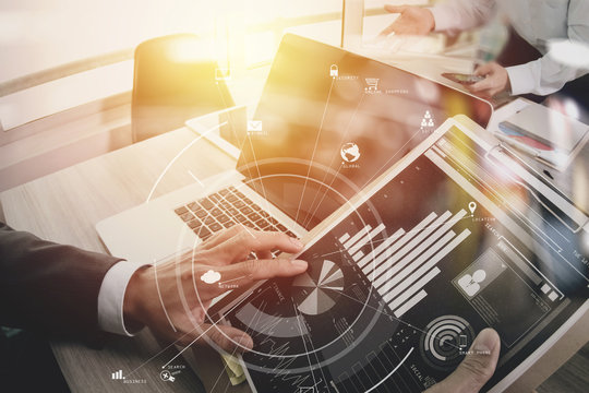 co working team meeting concept,businessman using mobile phone and digital tablet and laptop computer in modern office with virtual icon diagram