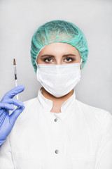 Doctor or scientist in blue gloves with syringe on white background