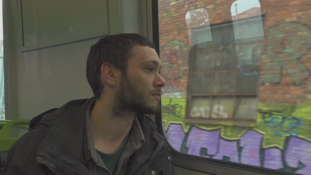 Thoughtful Boy Looking Outside Window of a Train