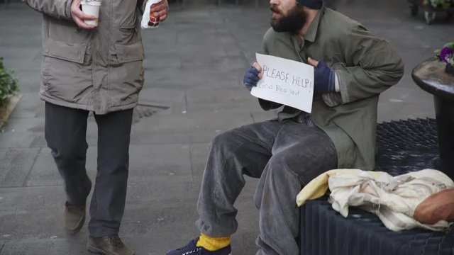 Compassion, mercy, goodness: gentleman offers breakfast to a homeless