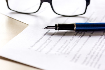 workspace with document, glasses and pen for sign for businessman day