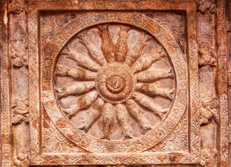 Great example of Indian rock-cut architecture. Ceiling with carved fish inside a wheel of life. 6th century cave temple in town Badami, India.